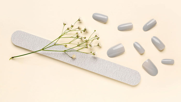 Gray fake nails and nail file with small flowers