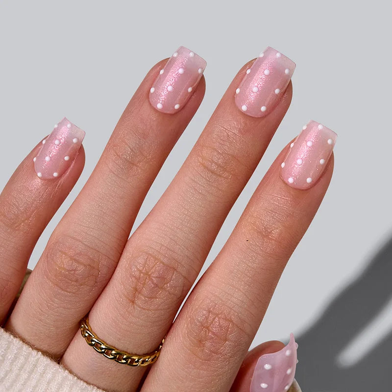 Sugar Pop short coffin nails with a shimmering pink base and polka dots